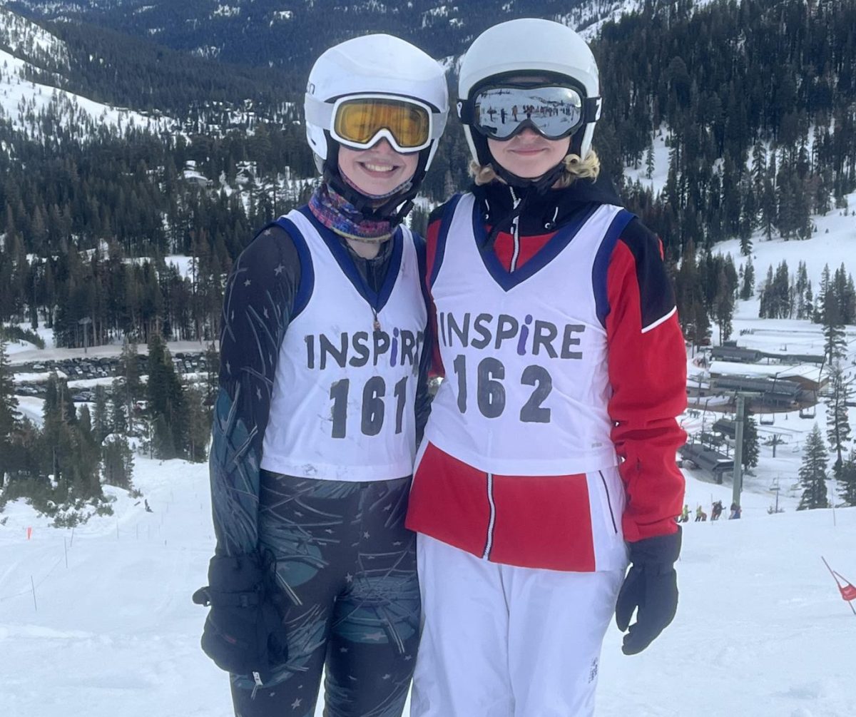 MK Kidd (10) and Abby Hanford (10) pose in homemade ski bibs after Inspires first ski race.